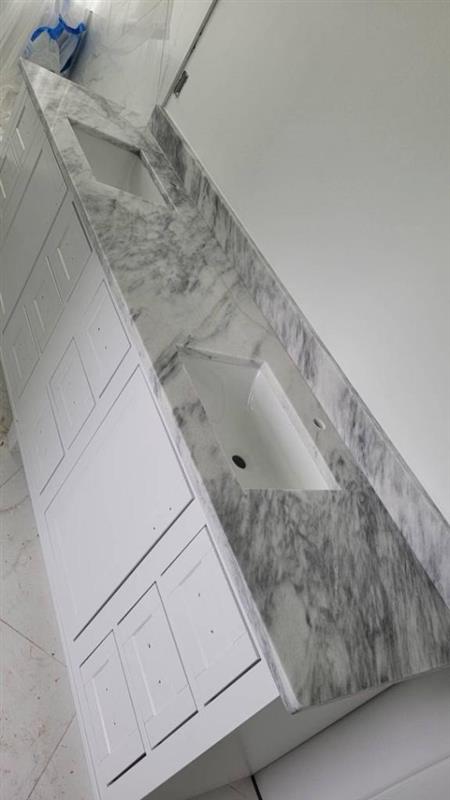 Phase 12 — Secondary bath vanity with marble countertops and undermount sinks