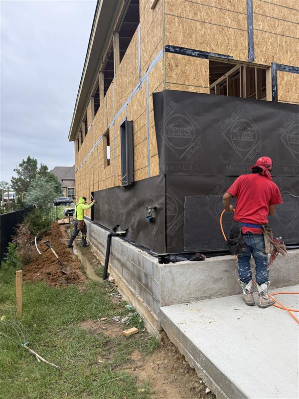 Phase 19 — Side wall wrapped in house wrap with crew fastening seams