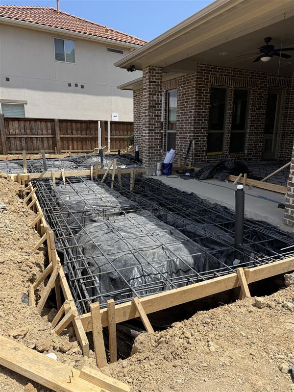 Phase 6 — Full foundation formed with rebar grid and vapor barrier ready for pour