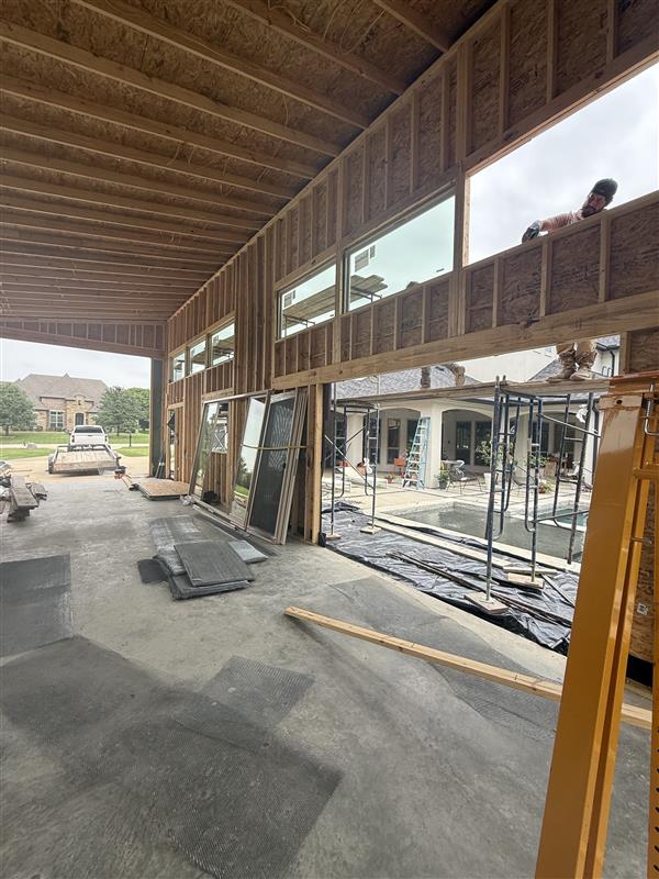 Phase 16 — Interior looking out through framed openings toward the pool and main house