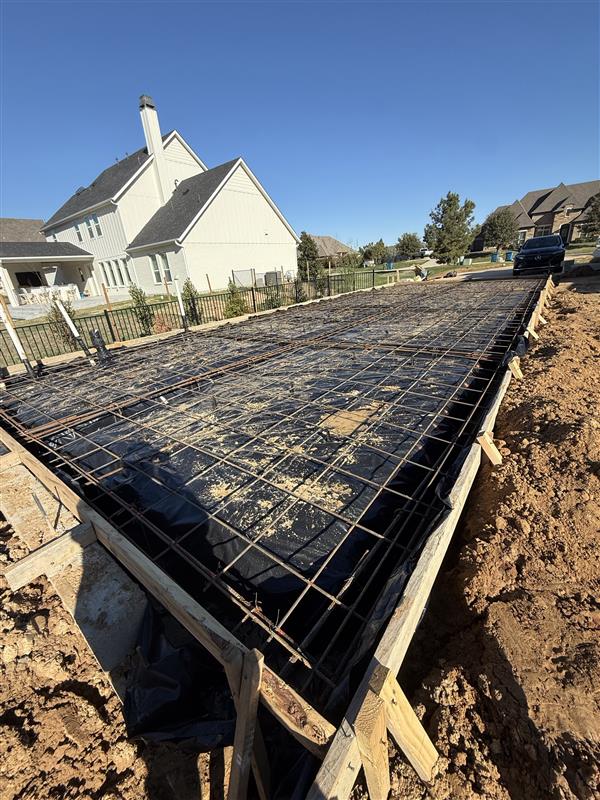 Phase 1 — Foundation prep: rebar grid tied over vapor barrier, ready for inspection
