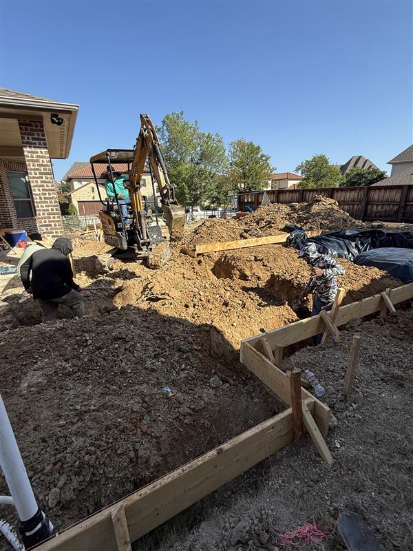 Phase 4 — Perimeter footing trenches formed and ready for rebar