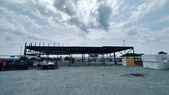 Phase 2 — Primary frame and roof structure set on prepared pad, ready for envelope work