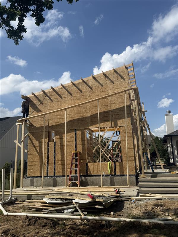 Phase 11 — Exterior sheathed with OSB and roof decking underway