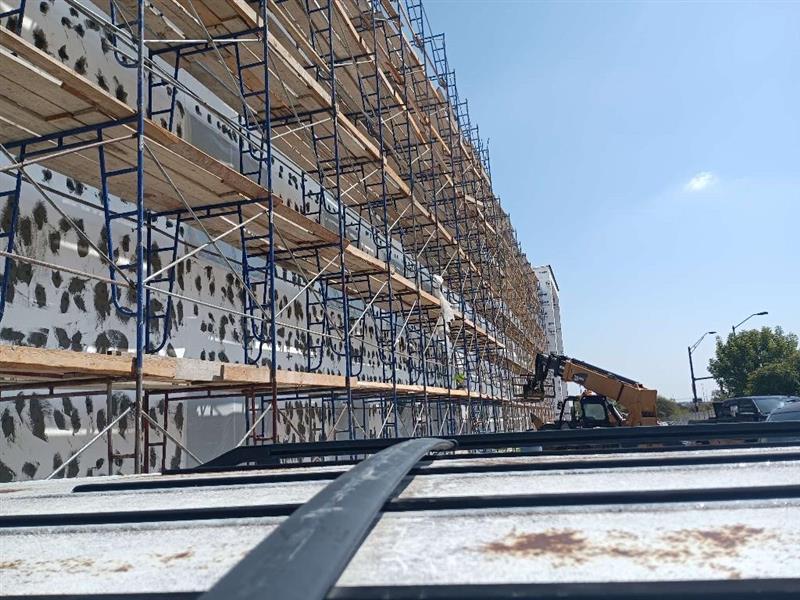Phase 7 — Scaffolding up along the elevation for exterior stucco/EIFS base-coat application