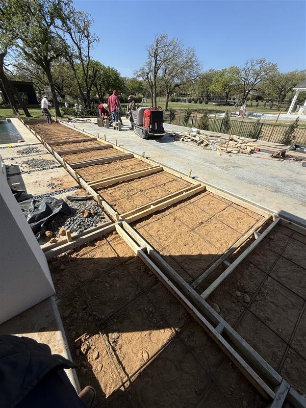 Phase 2 — Sectioned forms and rebar prepped along existing pool edge