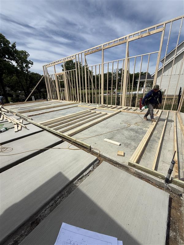 Phase 8 — Floor joists and wall framing complete for the covered structure