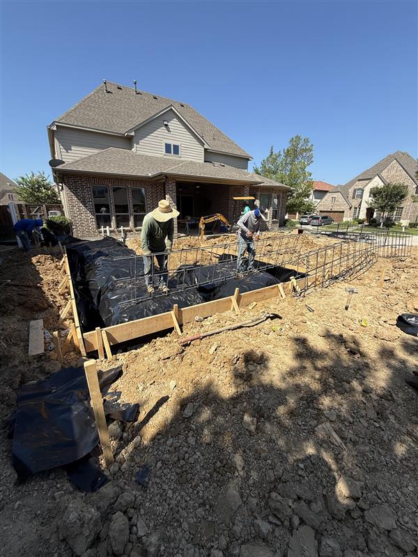 Phase 5 — Rebar cage tied over vapor barrier, prepped for inspection