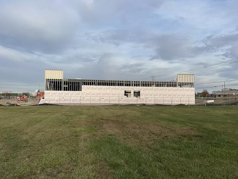 Phase 3 — Long elevation: exterior sheathing and weather barrier running the full building line