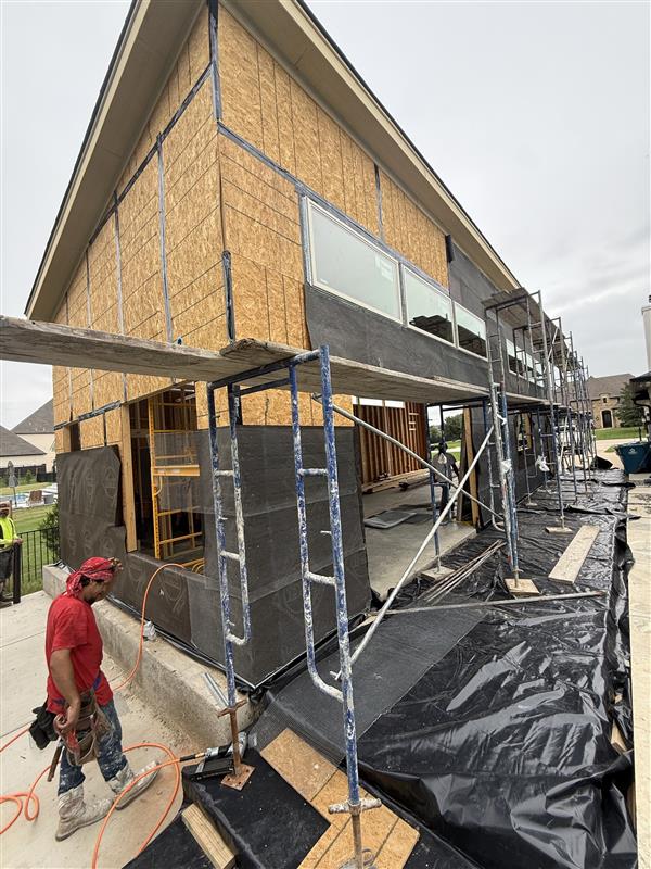 Phase 18 — Weather-resistant barrier going up over the OSB sheathing